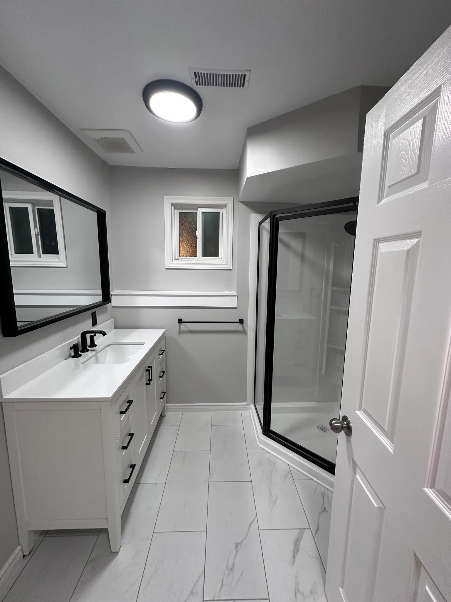 Bathroom with a white vanity and glass shower