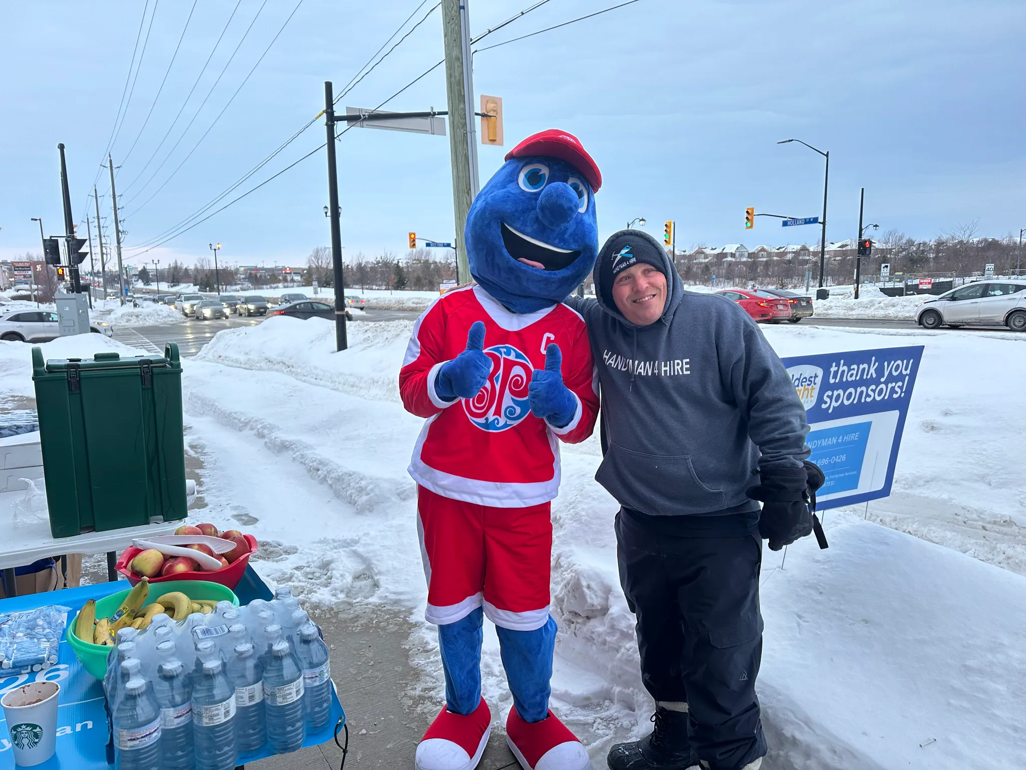 Robert with a mascot at a winter event