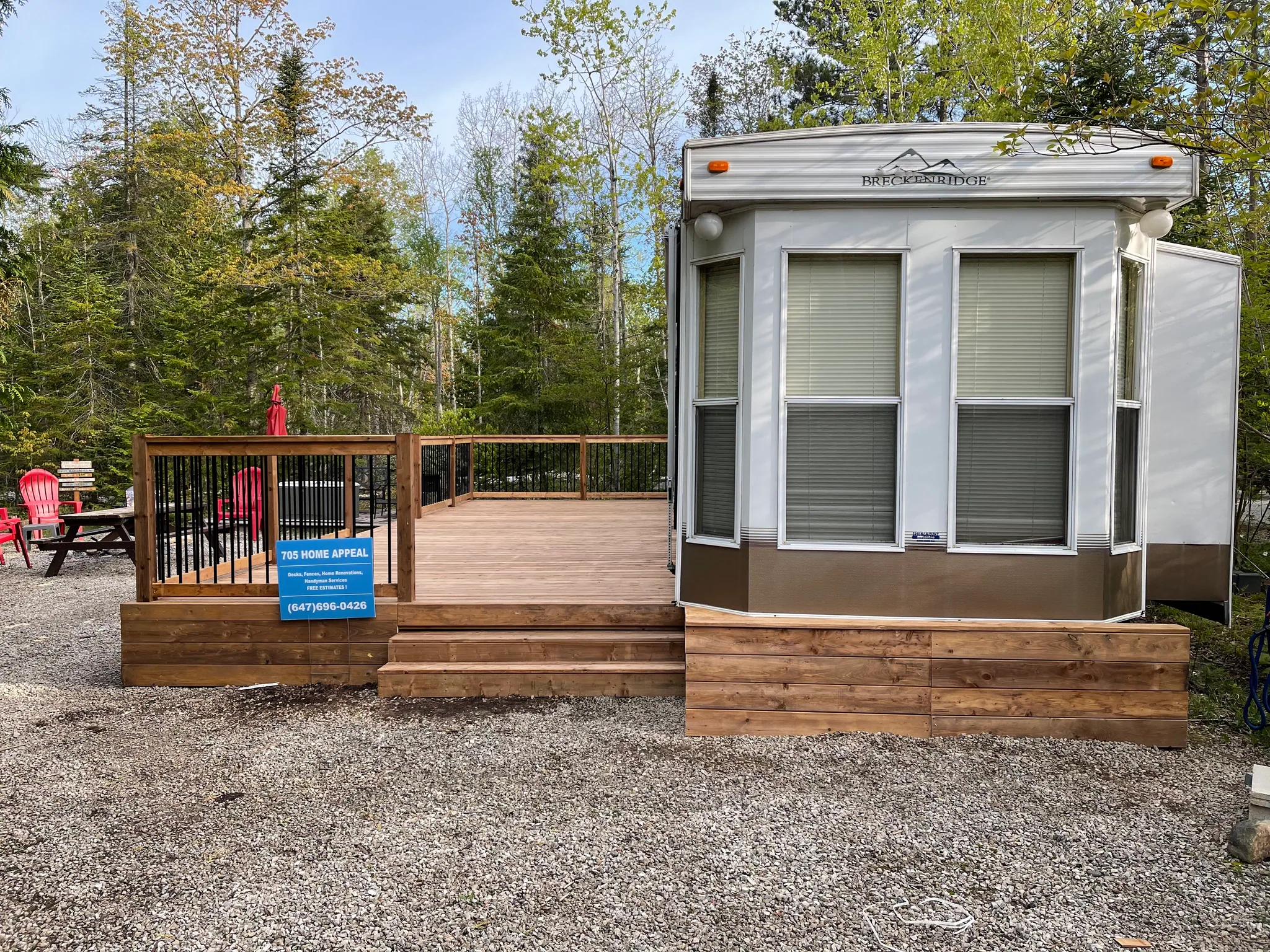 New wood deck and steps beside a trailer