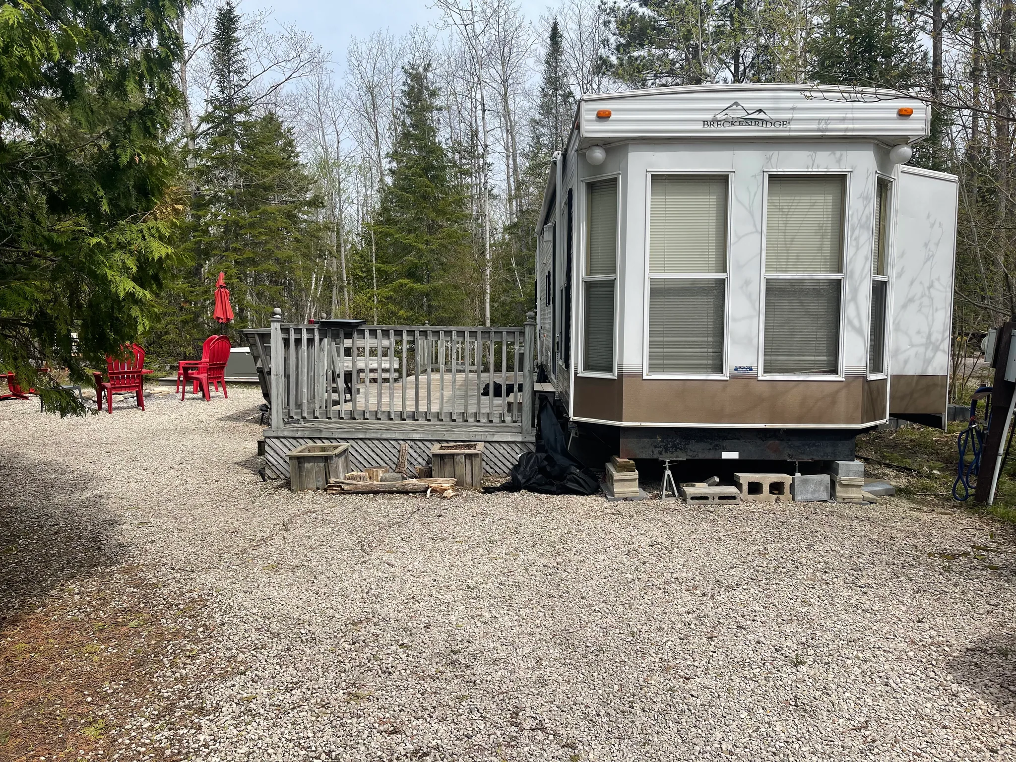 Old deck and railing beside a trailer