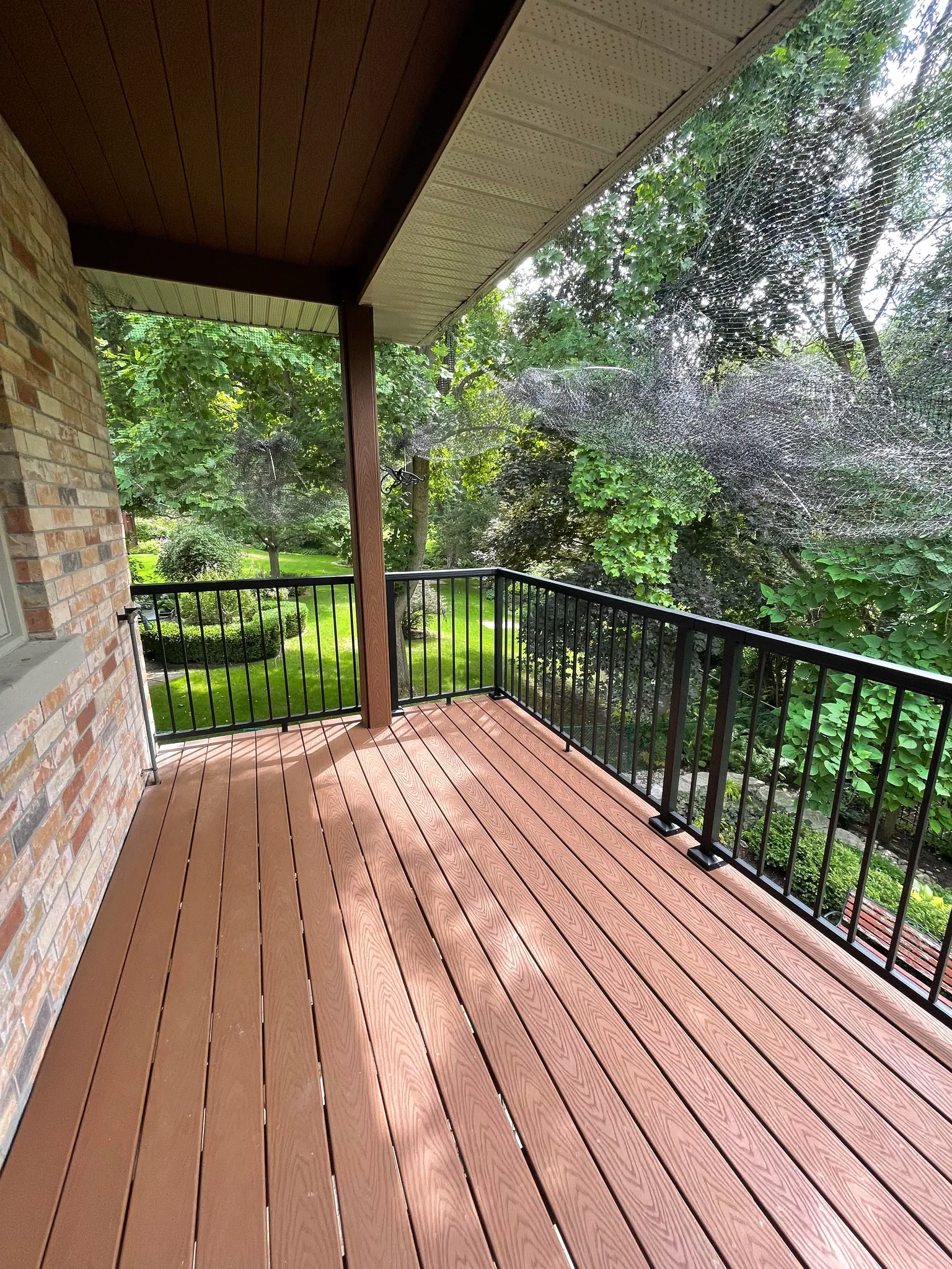 Same covered deck with composite boards and black railing