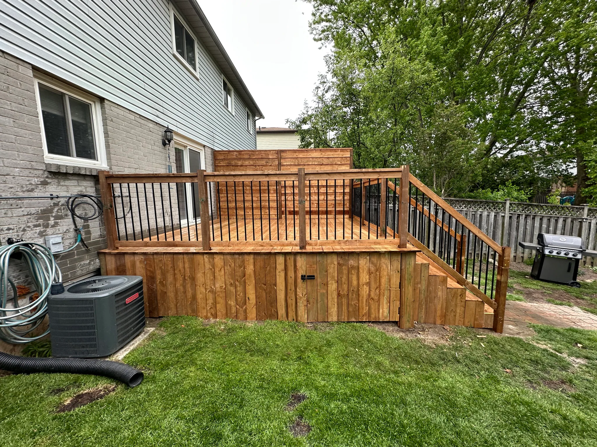 Raised wood deck with stairs and enclosed storage