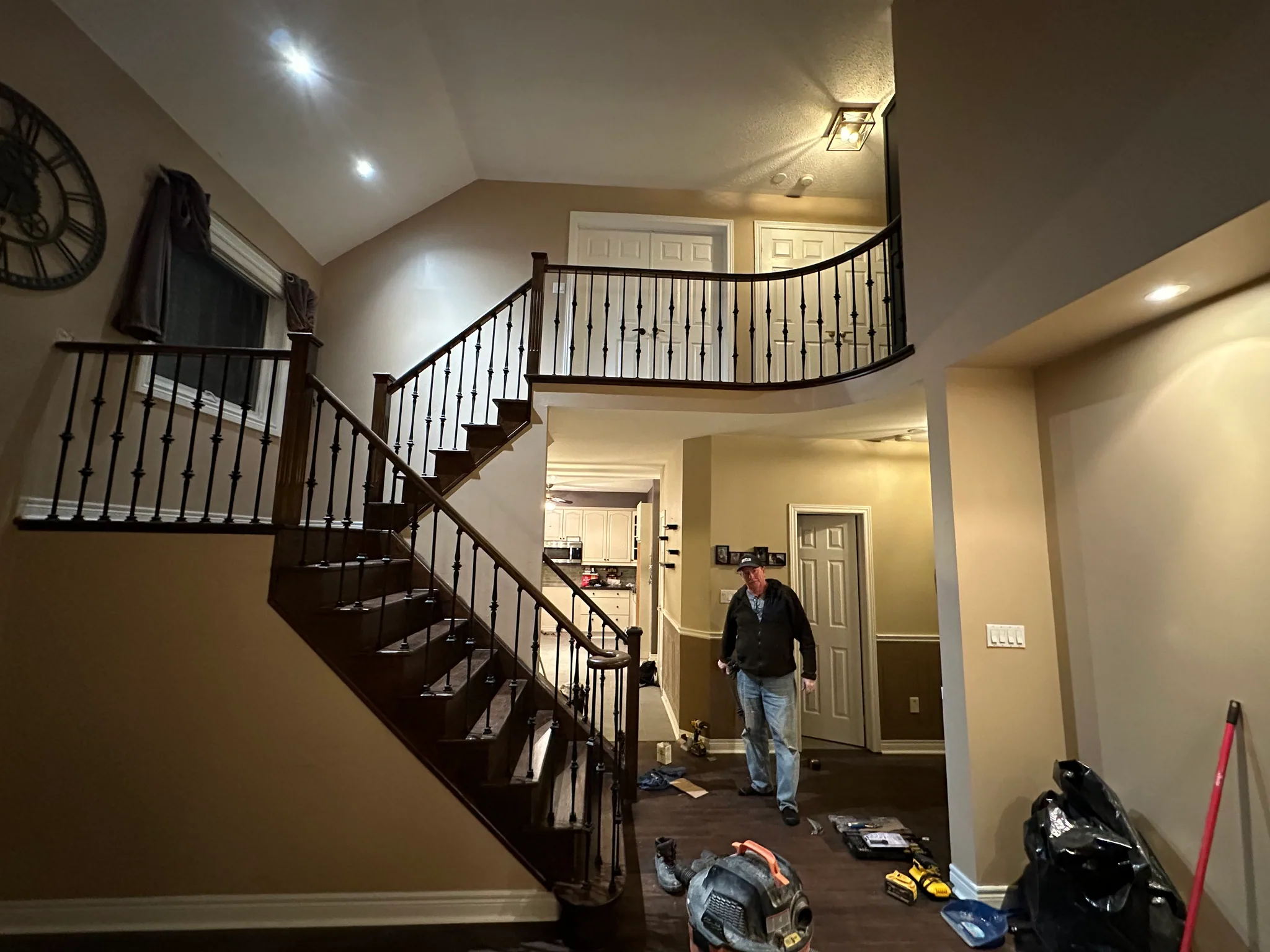 Refinished wood staircase with black metal railing