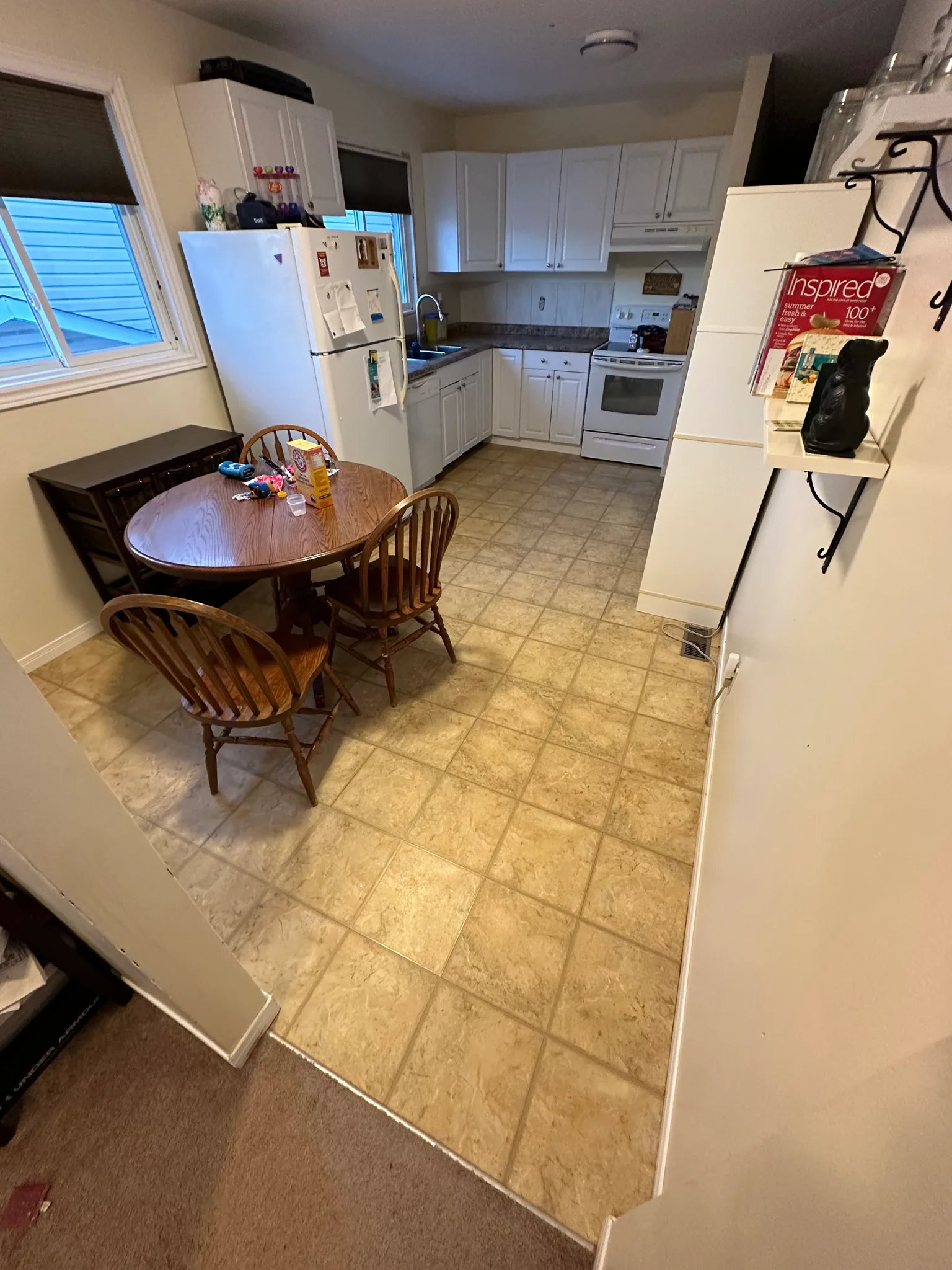 Square beige floor tiles around a kitchen dining table