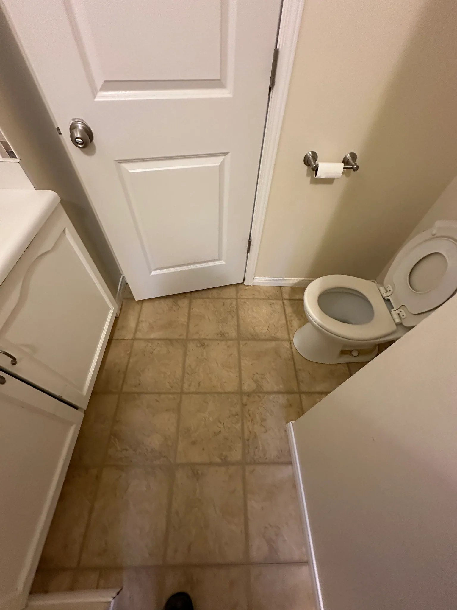 Square floor tiles fitted around a bathroom toilet and vanity