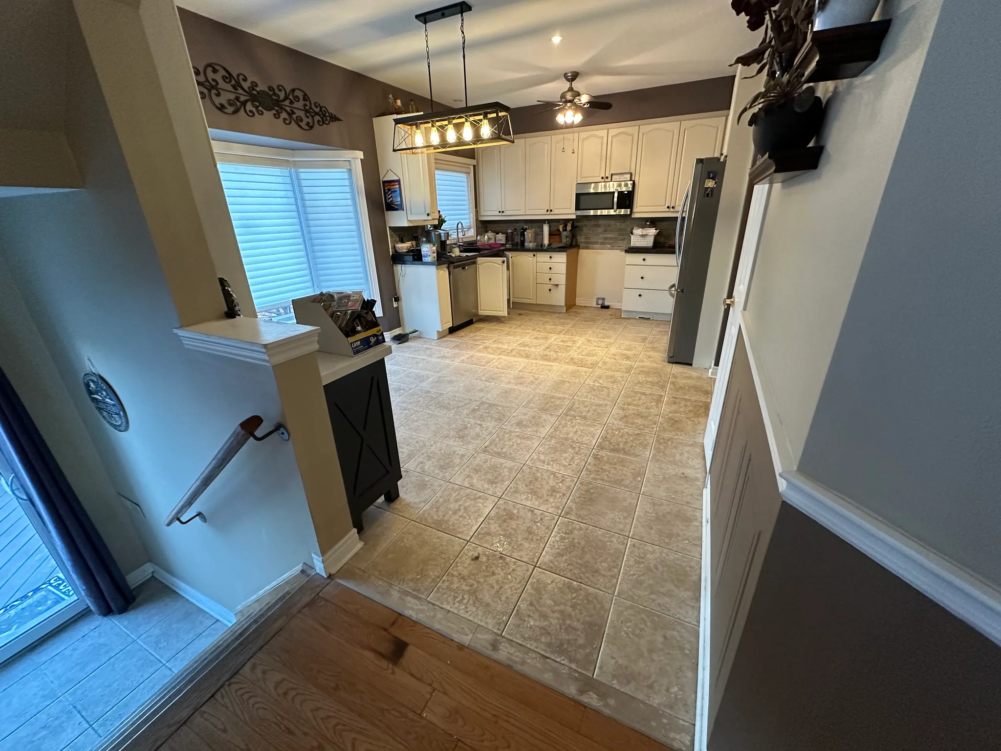 Tiled kitchen floor meeting a wood hallway floor